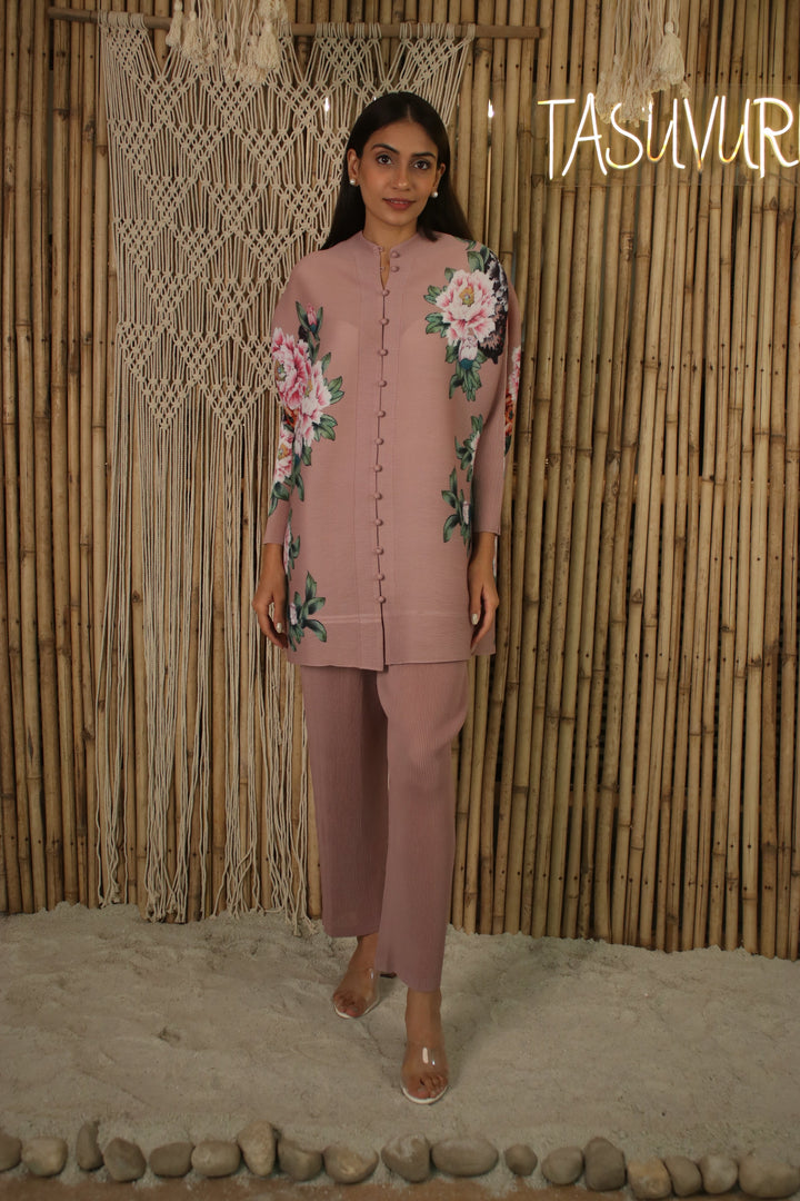 The floral shirt comes with center front button closure, dolman sleeves and an ankle length pleated pants.
