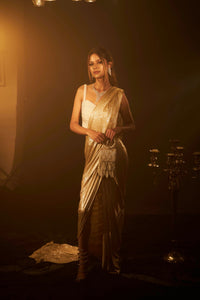 Shop Designer Metallic Shimmer Slit Saree & Embellished Pearl Blouse  for Women Online at Tasuvure. Buy Stylish Nude Saree & attached Palla for Weddings & Events Saia metallic slit saree with an embellished pearl blouse will definitely make you look sassy and elegant in an event. Tailored to perfection in a metallic fabric, the saree features a slit from the waist level and has an attached palla which creates a great fall. It comes with a pearl embellished blouse with dori attachments on the back.