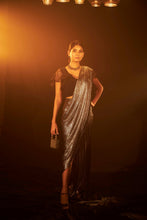Load image into Gallery viewer, Saia metallic slit saree with an embellished pearl blouse will definitely make you look sassy and elegant in an event.  Tailored to perfection in a metallic fabric, the saree features a slit from the waist level and has an attached palla which creates a great fall.  It comes with a pearl embellished blouse with a deep V-neckline and ruffle sleeves in organza and deep from the back.